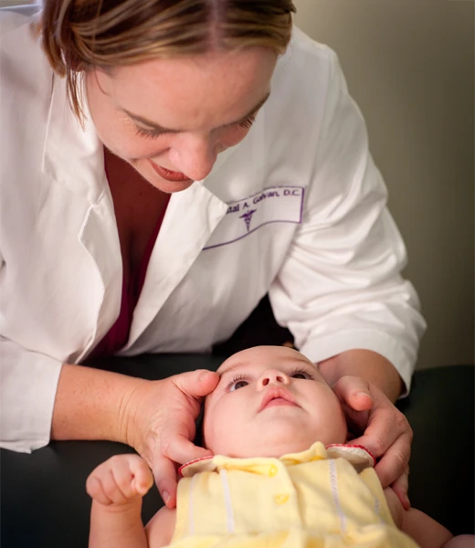 Dr. Crystal Galvan adjusting a pediatric patient's neck